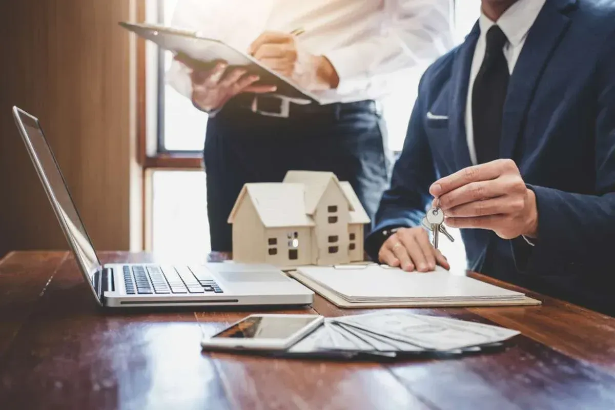 A real estate agent and sales manager team analyzing pricing of a rental lease and purchase agreement.