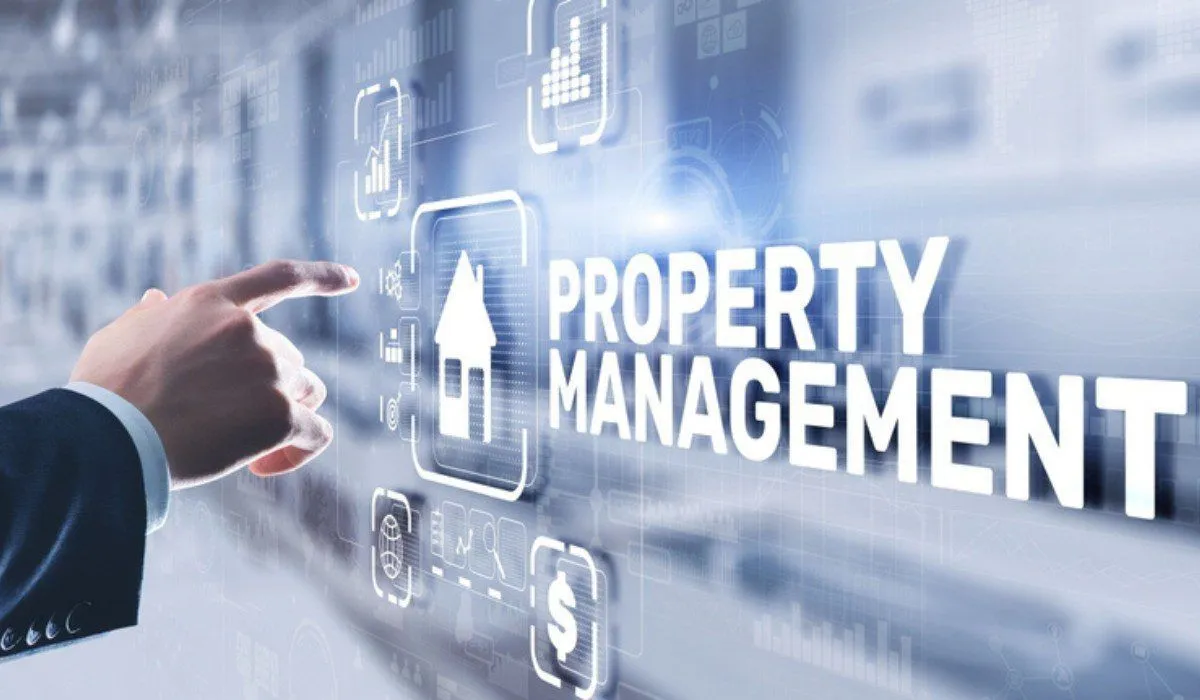 A property manager pointing at a property management concept on a digital display.